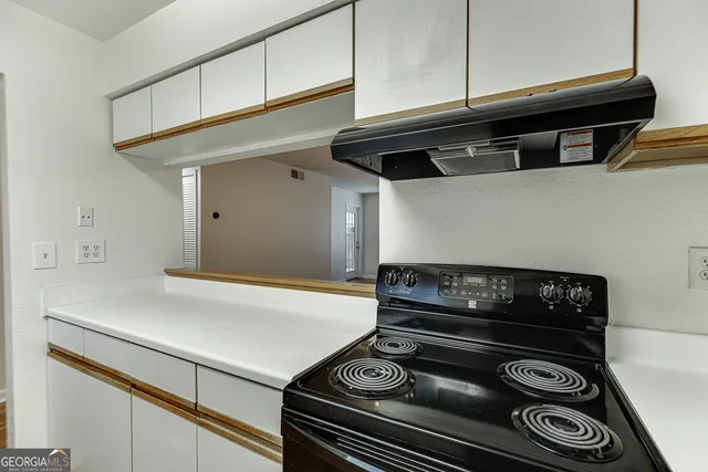 a stove top oven sitting inside of a kitchen