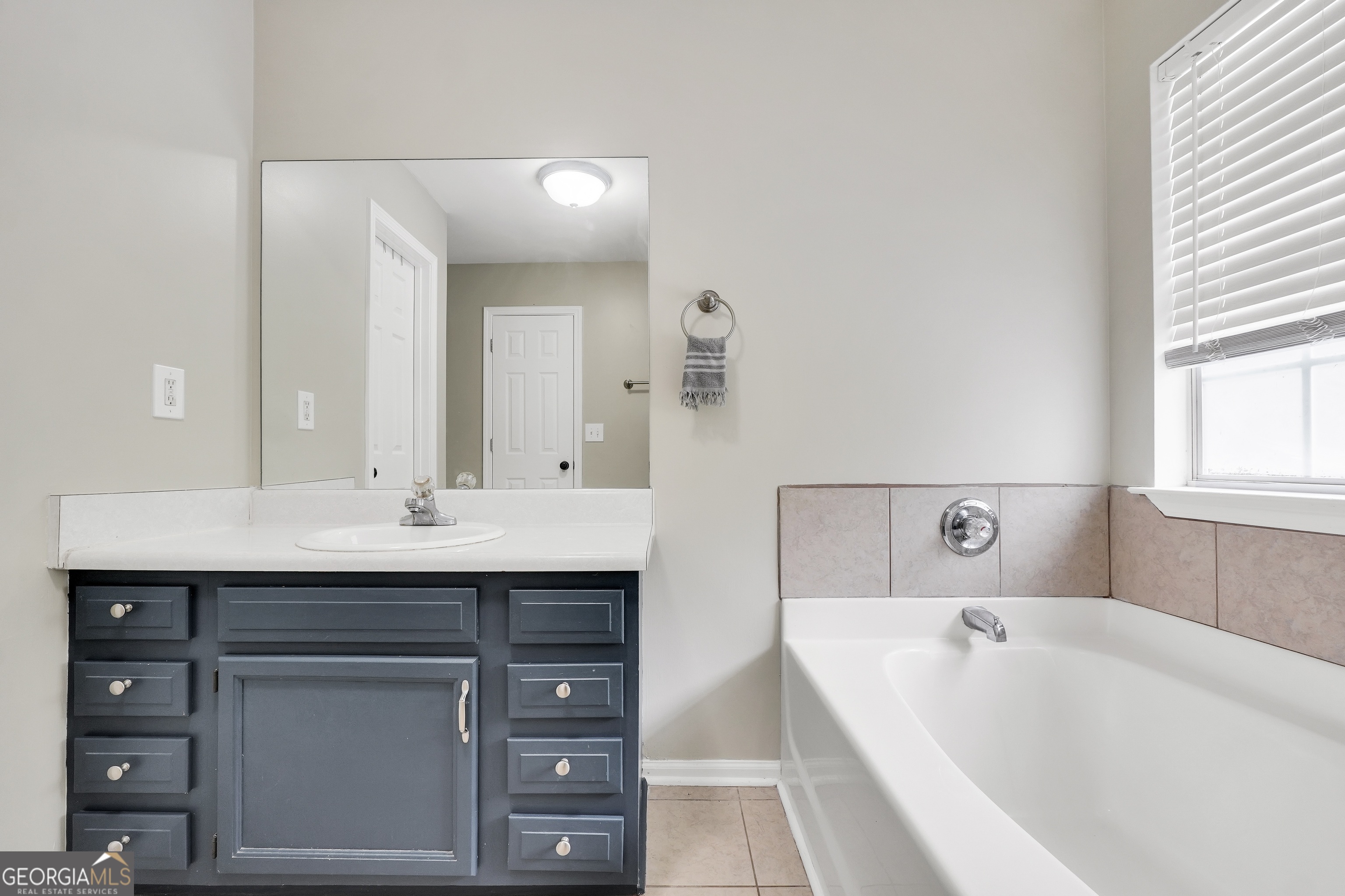 110 Westeria Way Jackson, GA 30233 - Photo 18 of 45 a bathroom with a tub sink and mirror