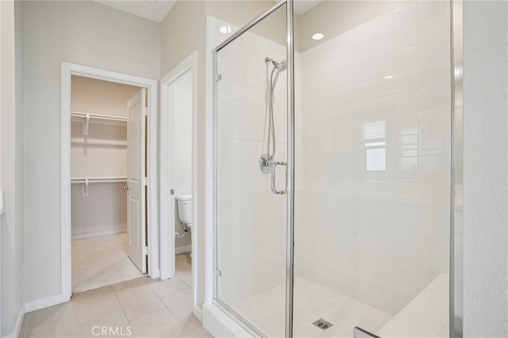 143 Frame Irvine, CA 92618 - Photo 15 of 41 a bathroom with a shower and a glass door