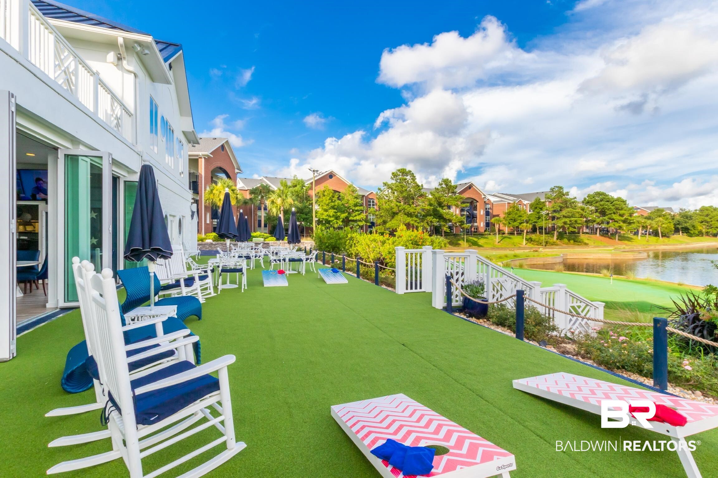 20050 Oak Road East Gulf Shores, AL 36542 - Photo 9 of 14 View of green lawn featuring a water view and a patio