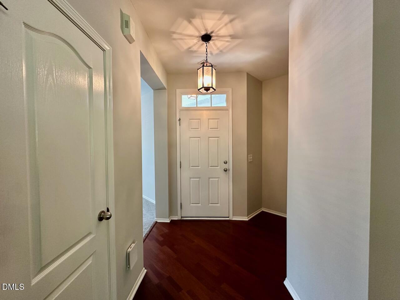 8208 Stone Cellar Drive Raleigh, NC 27613 - Photo 4 of 34 a view of a hallway with windows and chandelier