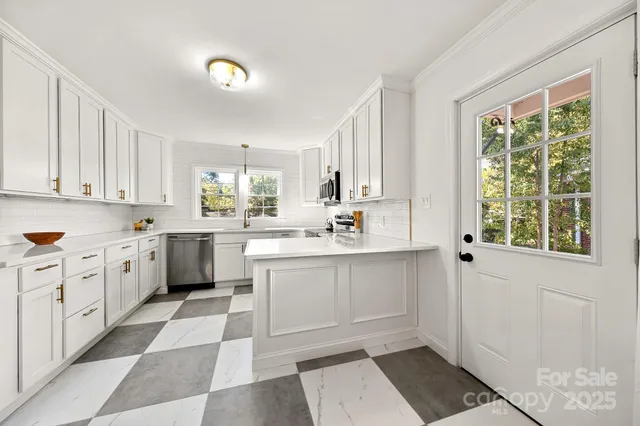 a kitchen with a white cabinets and sink