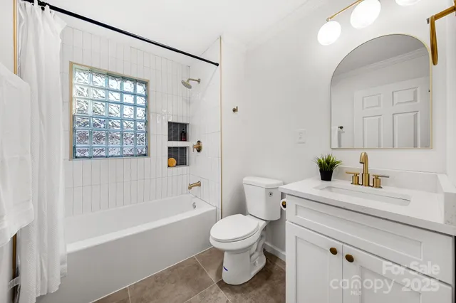 a bathroom with a granite countertop sink toilet a large mirror a bathtub and shower