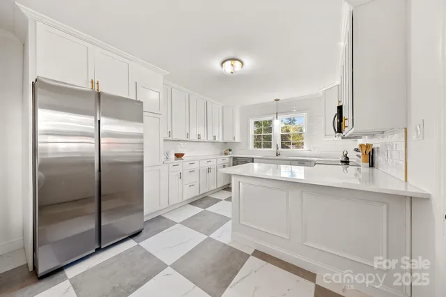 a kitchen with stainless steel appliances a refrigerator sink and cabinets