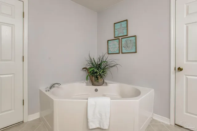 a bedroom with a large bed and a flat screen tv