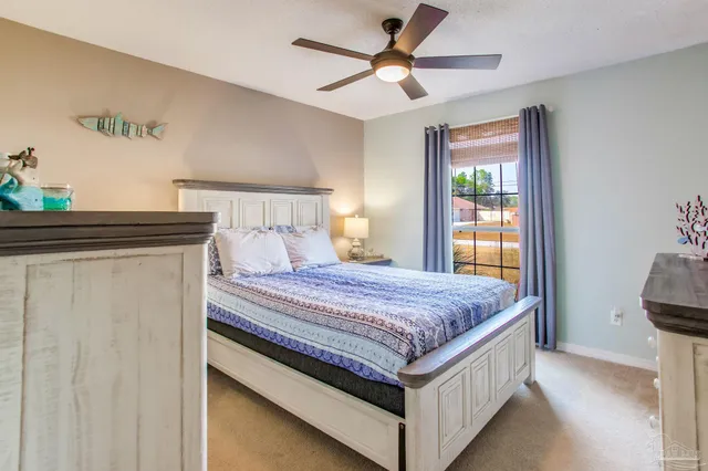 a dining room with furniture and a floor to ceiling window