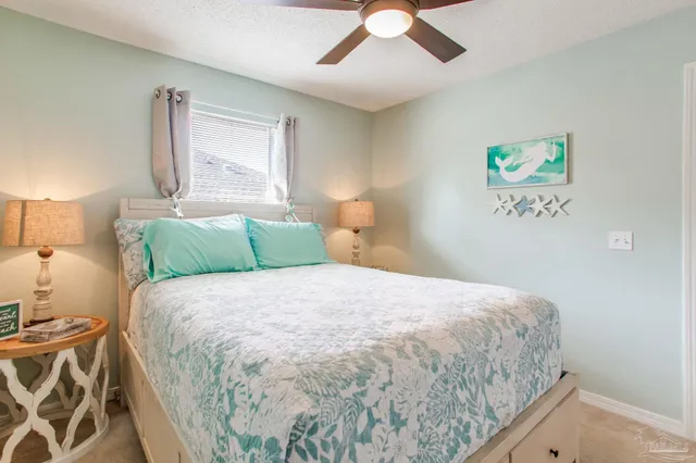 a living room with furniture and large windows