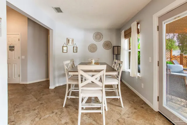 a building outdoor space with patio furniture and potted plants