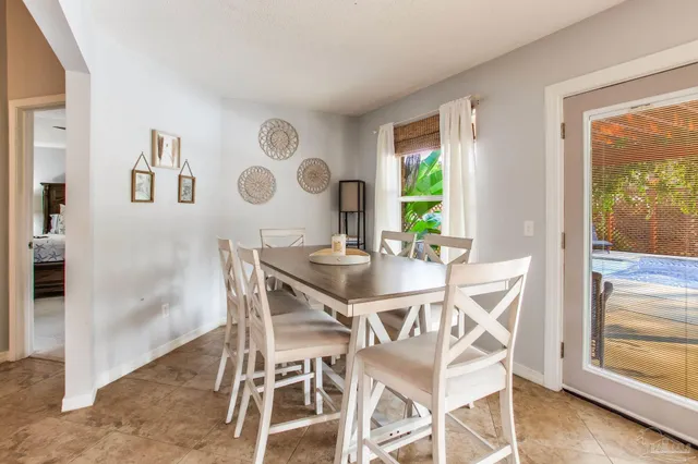 a view of a swimming pool with a patio and a yard
