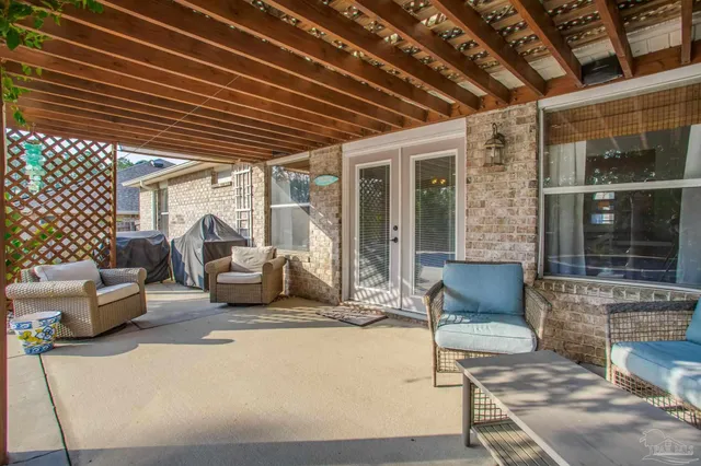 a view of a balcony with two chairs and a potted plant