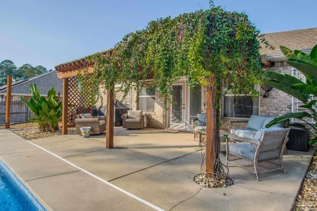 a front view of a house with garden and tree