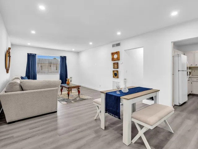 a front view of a house with a garden and plants