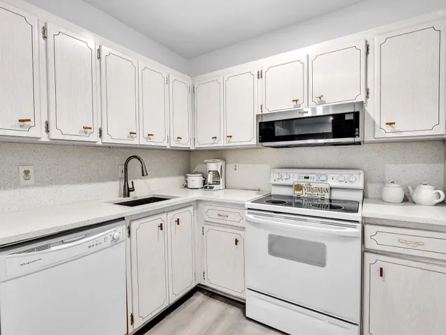 a white refrigerator freezer sitting inside of a kitchen