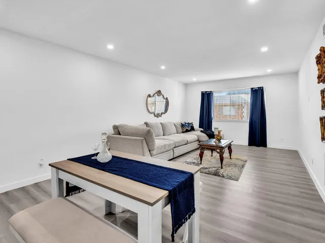a living room with furniture and a mirror