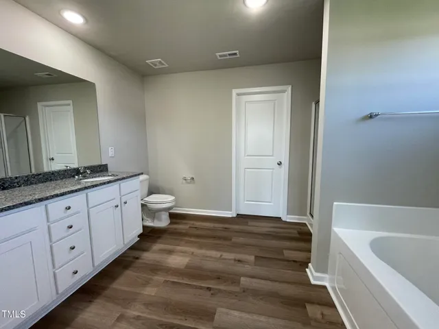 a view of a kitchen counter space and wooden floor