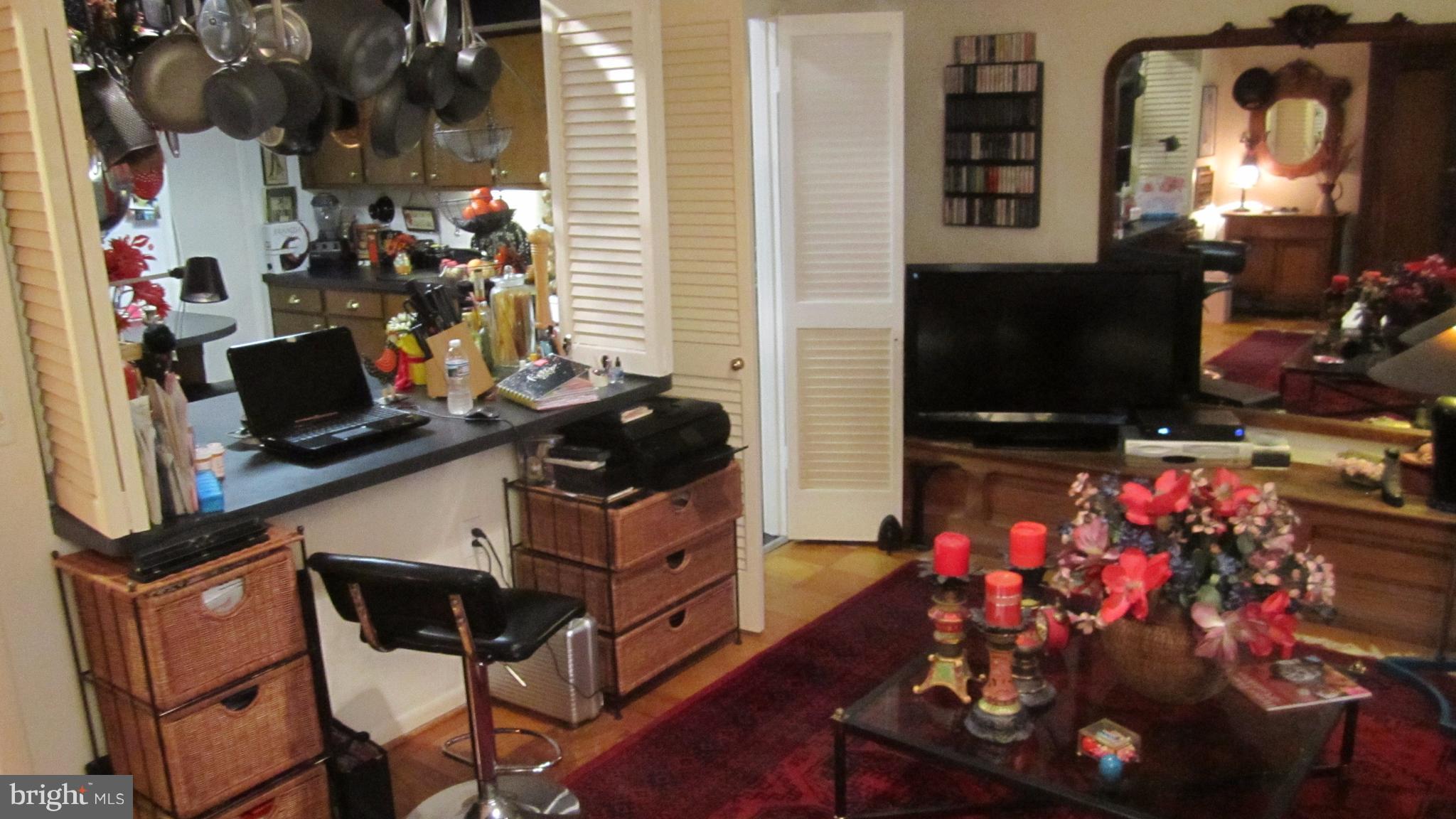 110 Cross Keys Road, Unit R110F Baltimore, MD 21210 - Photo 12 of 30 a room filled with furniture and a flat screen tv