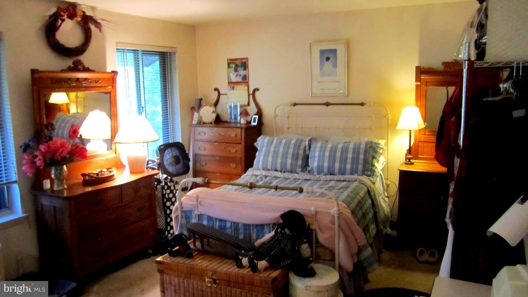 110 Cross Keys Road, Unit R110F Baltimore, MD 21210 - Photo 17 of 30 a bedroom with a bed and wooden floor