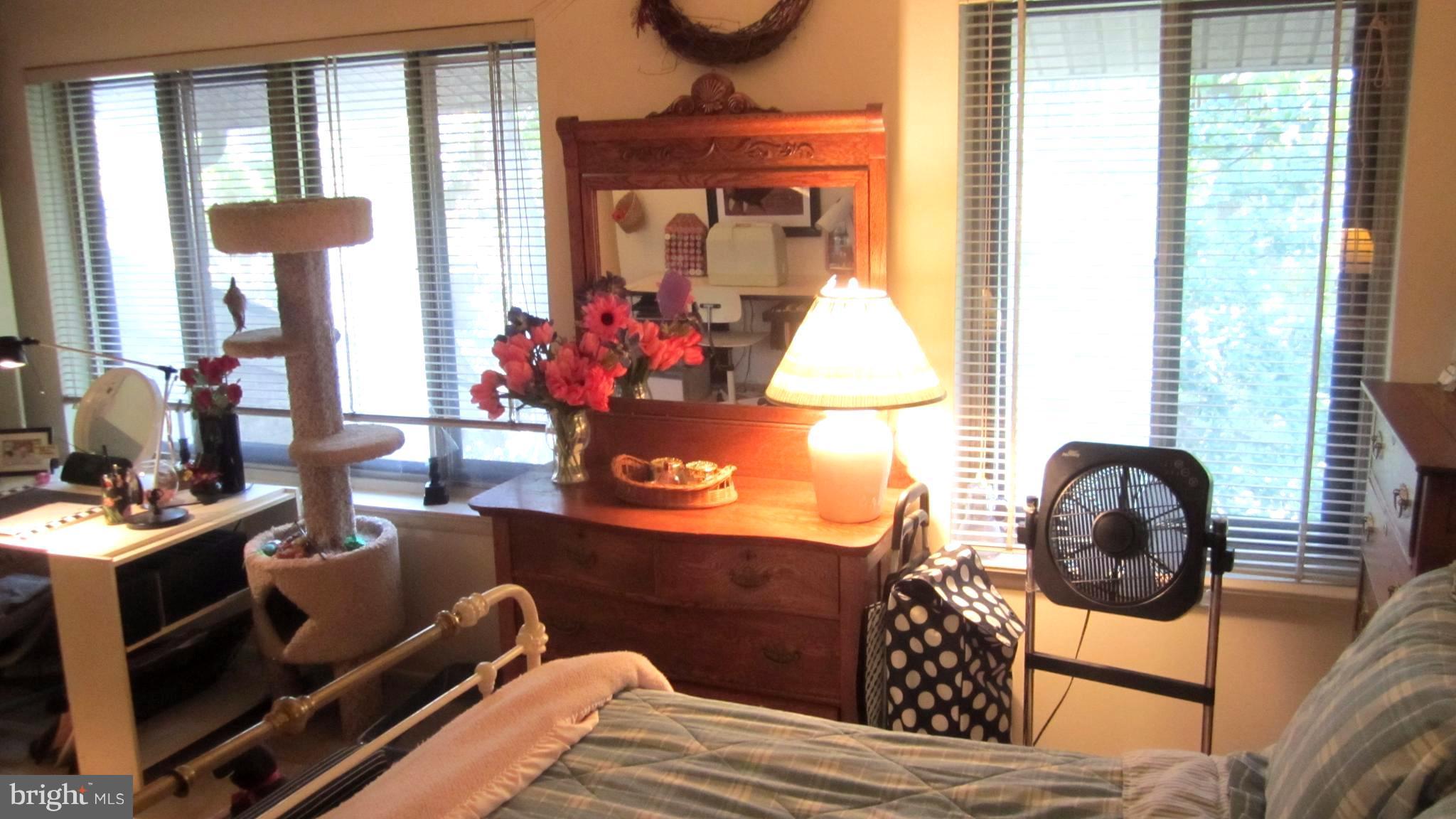 110 Cross Keys Road, Unit R110F Baltimore, MD 21210 - Photo 18 of 30 a bedroom with a bed and balcony