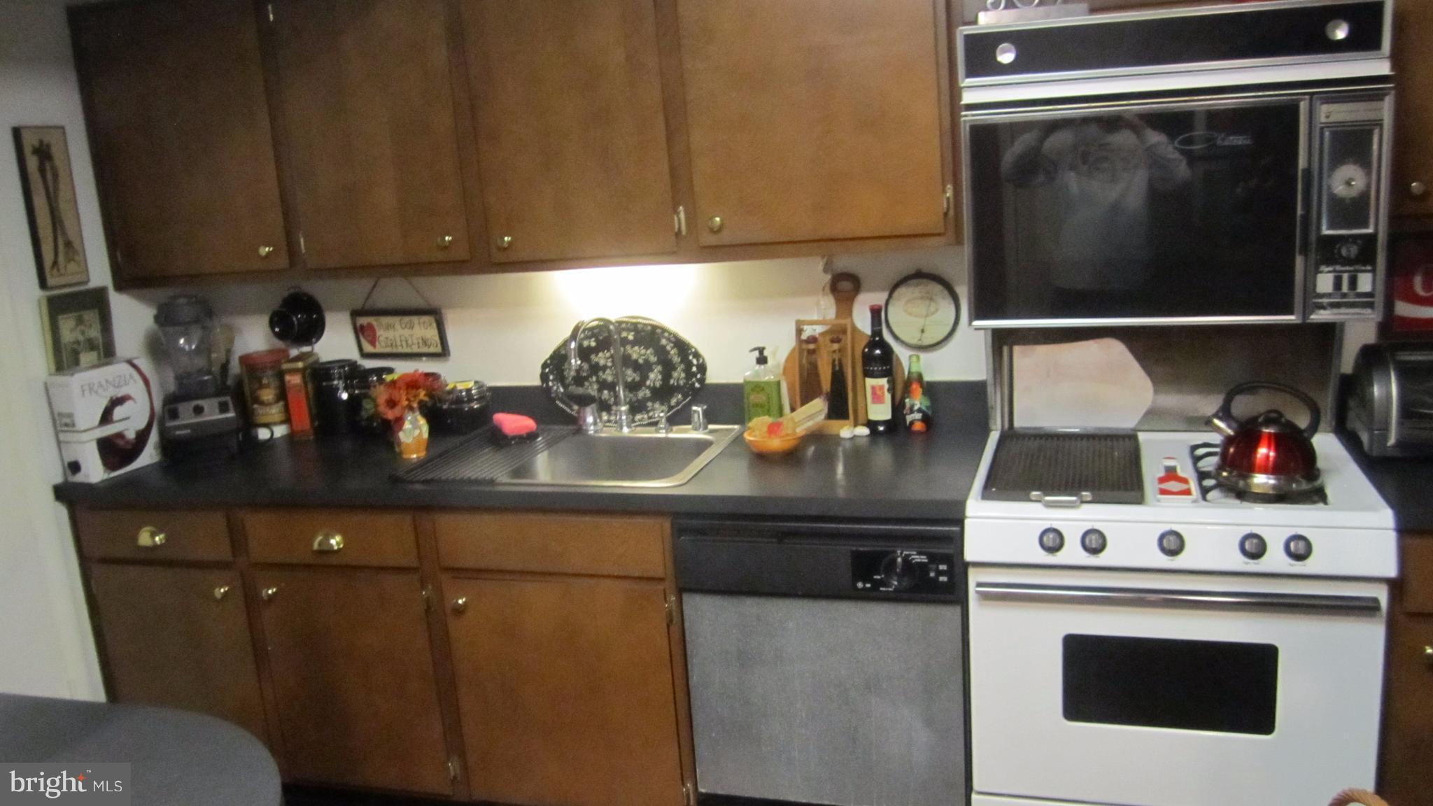 110 Cross Keys Road, Unit R110F Baltimore, MD 21210 - Photo 10 of 30 a kitchen with a stove and cabinets