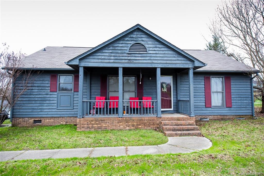 a front view of a house with a yard and fence