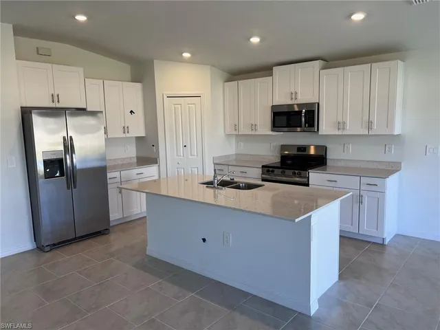 a view of a kitchen with a sink and a window