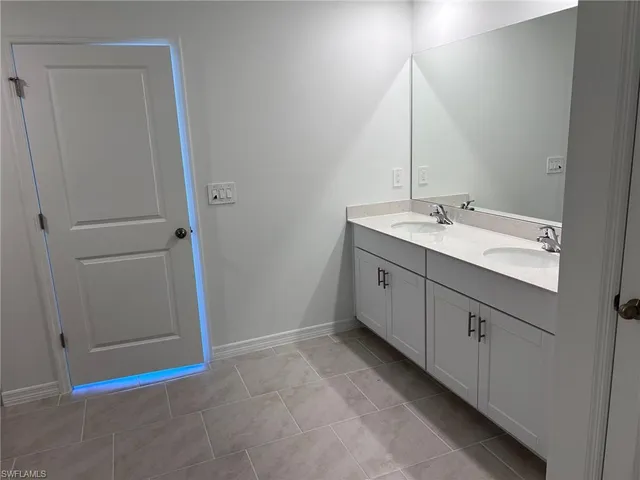 a kitchen with a sink cabinets and a window