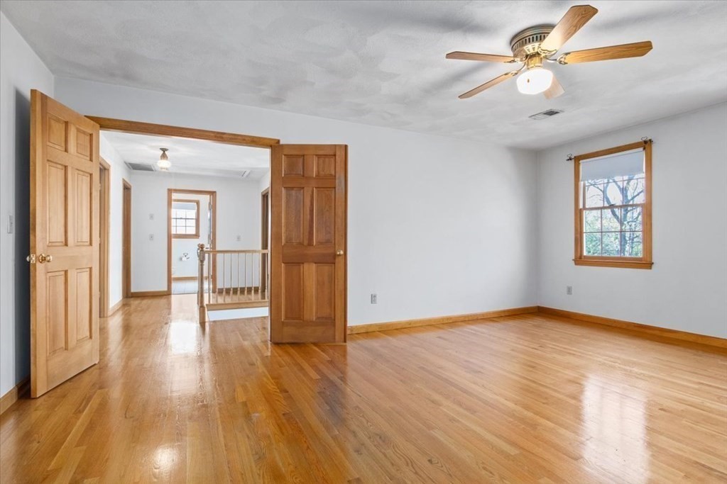 72 Jefferson Road Franklin, MA 02038 - Photo 16 of 33 a view of an empty room with window a ceiling fan and wooden floor