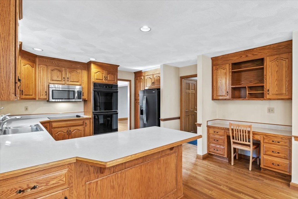 72 Jefferson Road Franklin, MA 02038 - Photo 3 of 33 a kitchen with stainless steel appliances granite countertop a refrigerator a stove top oven and a dining table with wooden floor