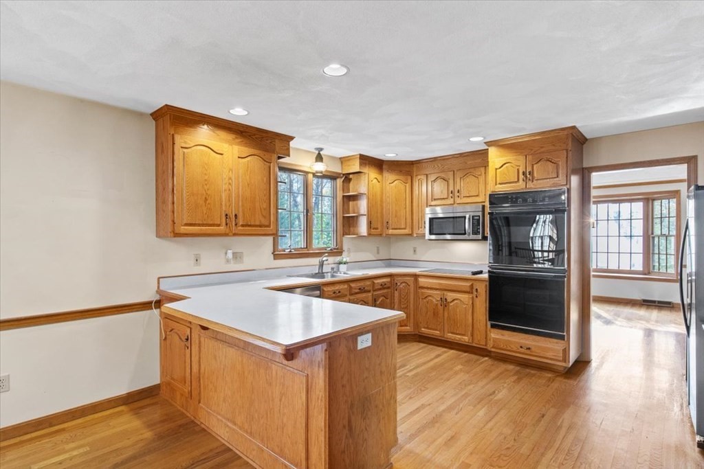 72 Jefferson Road Franklin, MA 02038 - Photo 4 of 33 a kitchen with stainless steel appliances granite countertop a sink stove and wooden floor