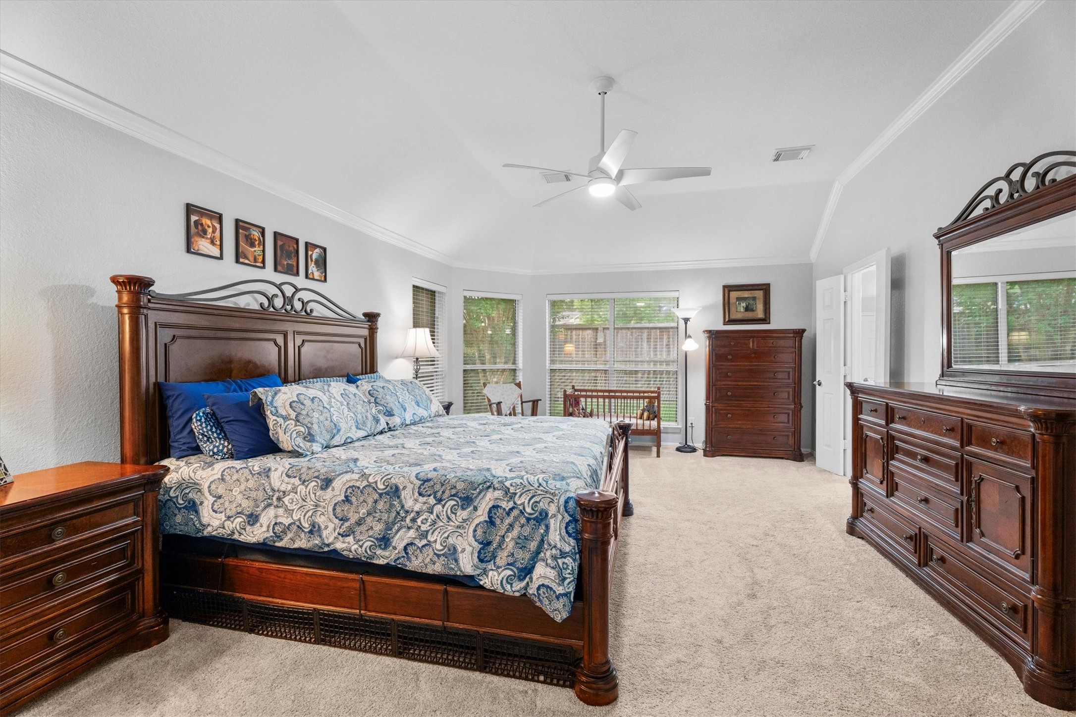 9406 Lochflora Drive Spring, TX 77379 - Photo 26 of 49 a bedroom with a large bed and a dresser