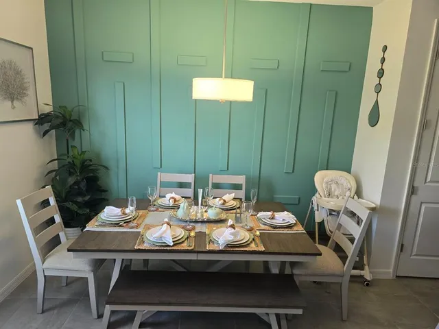 a view of a dining room with furniture and chandelier