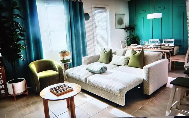 a living room with furniture and a potted plant