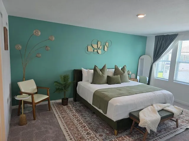 a bed sitting in a room next to a window