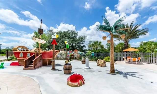 a roof deck with table and chairs potted plants