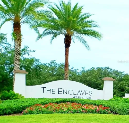 a sign that is sitting in front of flowers