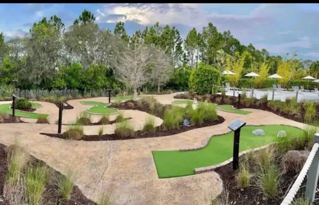 a view of yard with swimming pool and green space