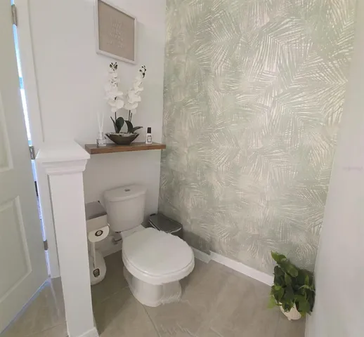 a white toilet sitting next to a white sink