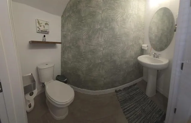 a bathroom with a toilet and a sink