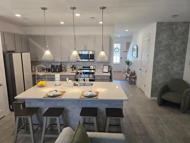 a large kitchen with a table and chairs