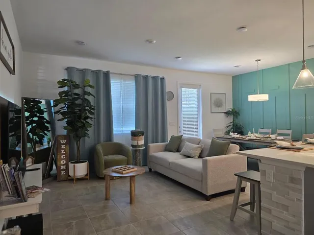 a living room with furniture and a potted plant