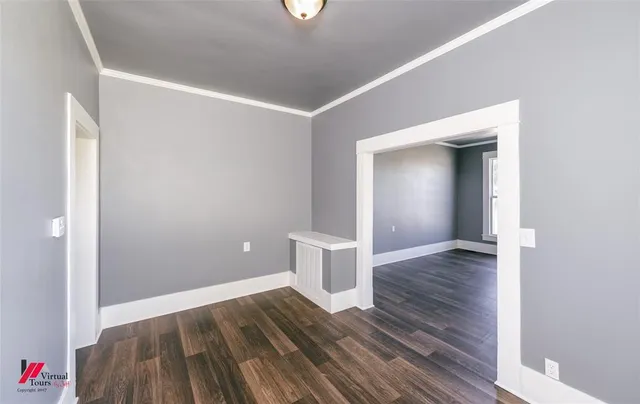 a view of a room with wooden floor and bathroom