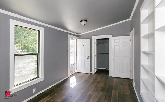 a big room with wooden floor and natural light