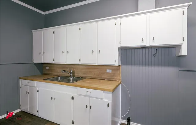 a kitchen with a sink and cabinets