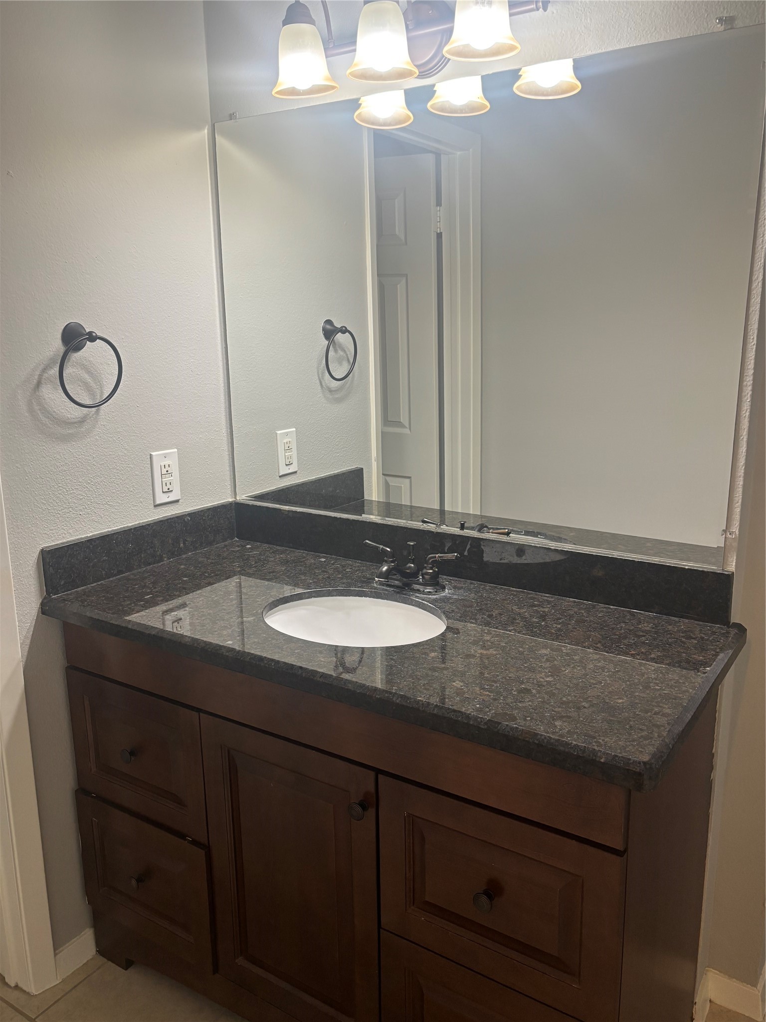 73 South Waxberry Road The Woodlands, TX 77381 - Photo 20 of 23 a bathroom with a granite countertop sink a mirror and shower