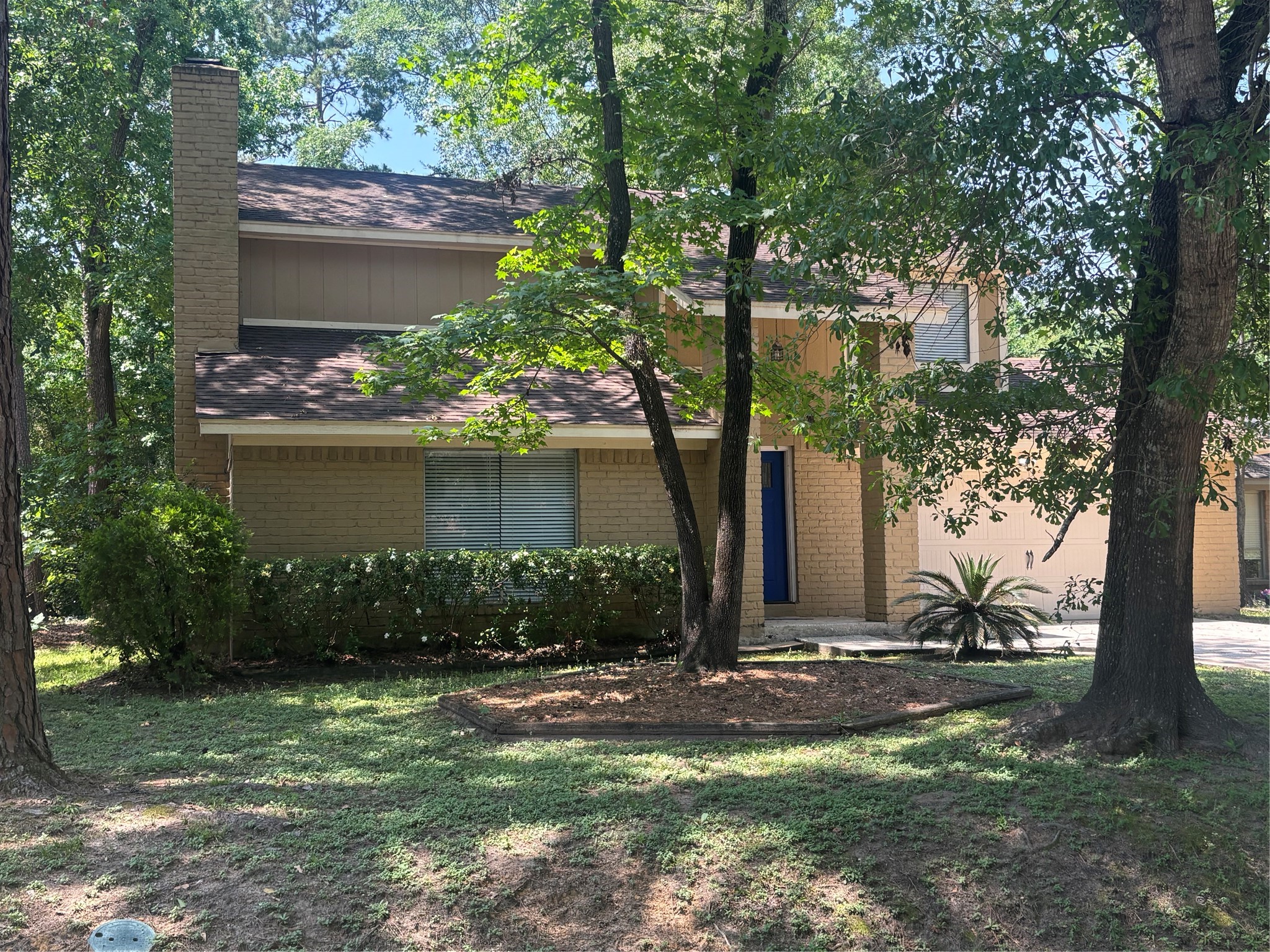 73 South Waxberry Road The Woodlands, TX 77381 - Photo 21 of 23 a front view of a house with garden