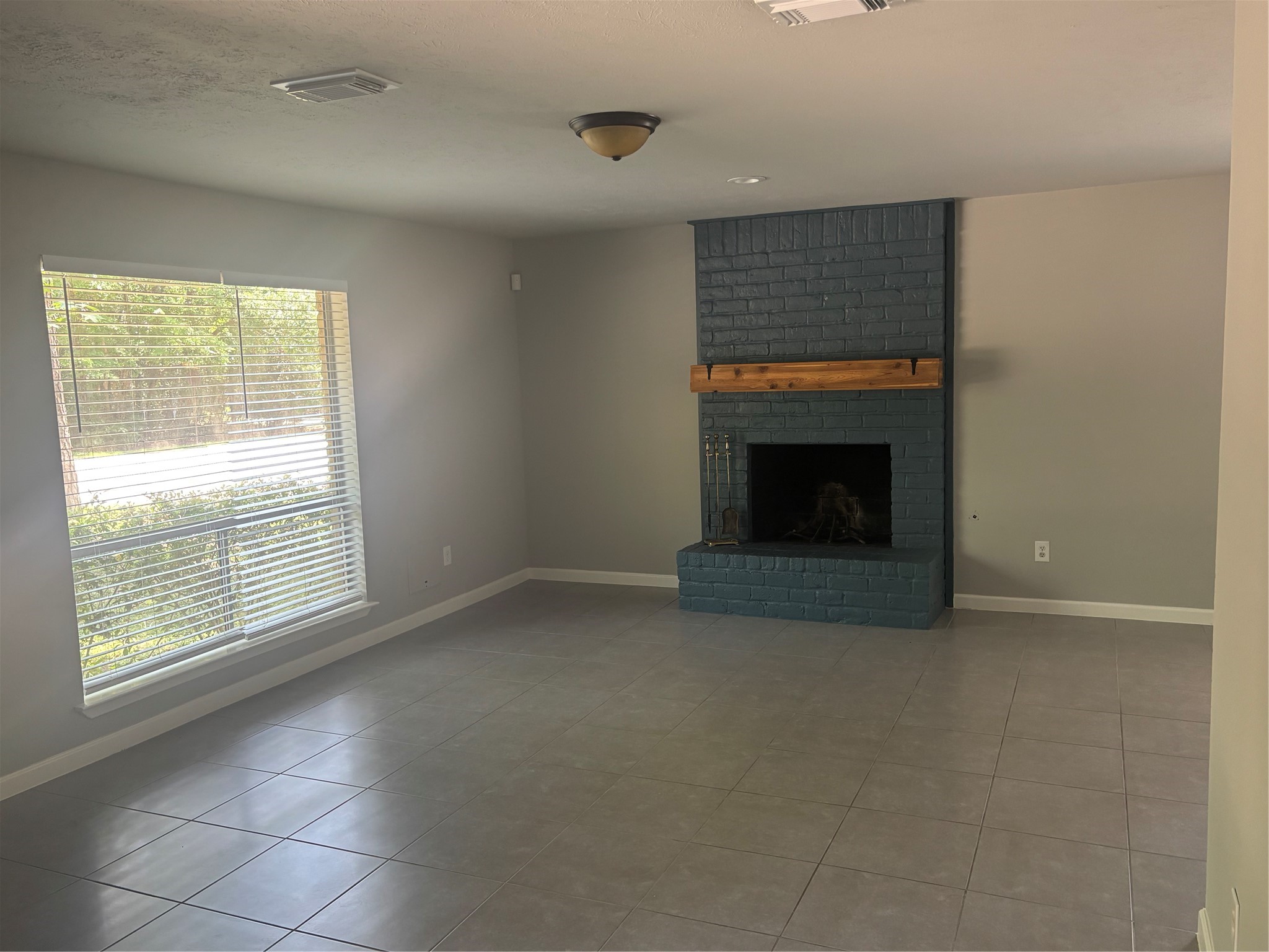 73 South Waxberry Road The Woodlands, TX 77381 - Photo 3 of 23 a view of empty room with a fireplace