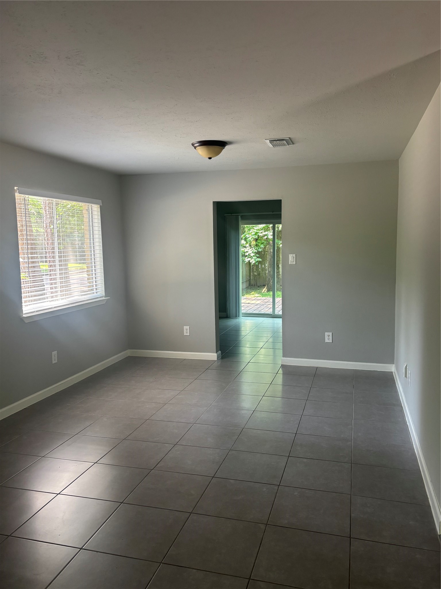 73 South Waxberry Road The Woodlands, TX 77381 - Photo 4 of 23 a view of an empty room with a window
