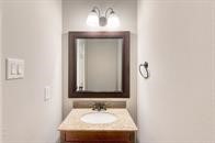 73 South Waxberry Road The Woodlands, TX 77381 - Photo 4 of 8 a bathroom with a sink and a mirror