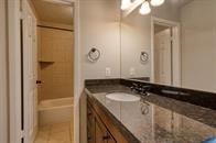 73 South Waxberry Road The Woodlands, TX 77381 - Photo 6 of 8 a bathroom with a sink and a mirror
