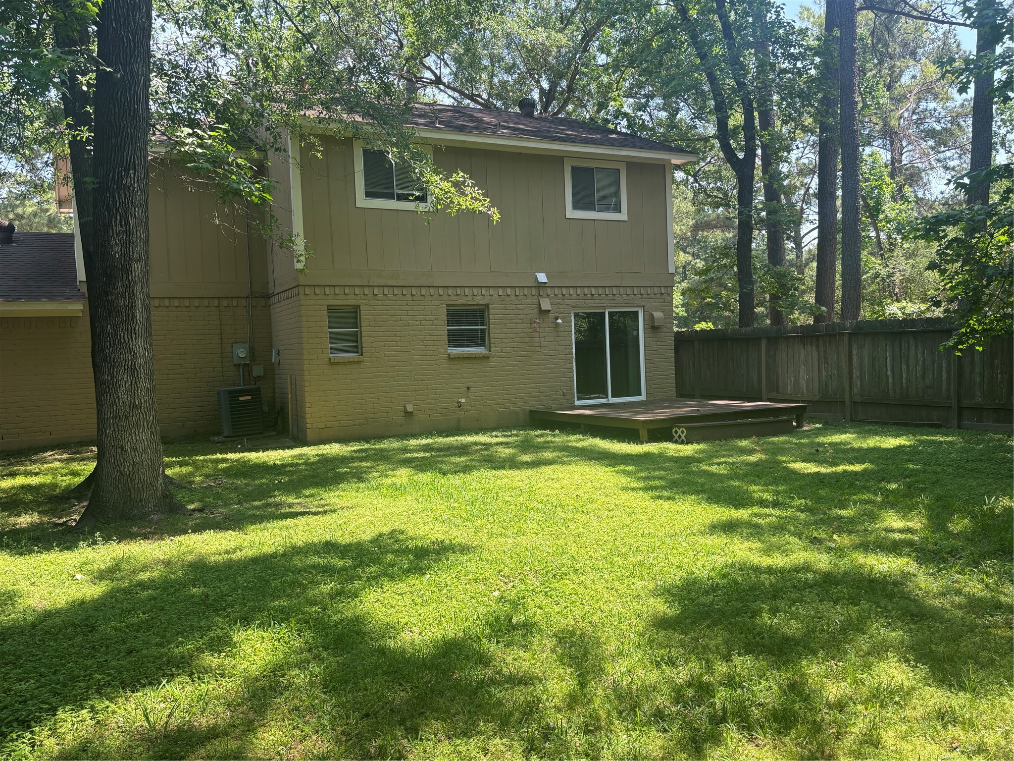 73 South Waxberry Road The Woodlands, TX 77381 - Photo 6 of 23 a backyard of a house with lots of green space